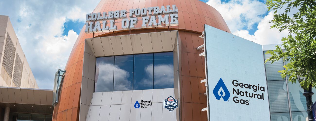 Exterior of College Football Hall of Fame building with GNG logo on screen