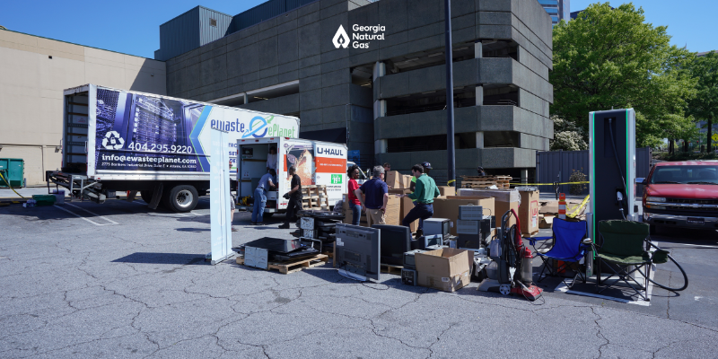 People collecting electronics to recycle in boxes