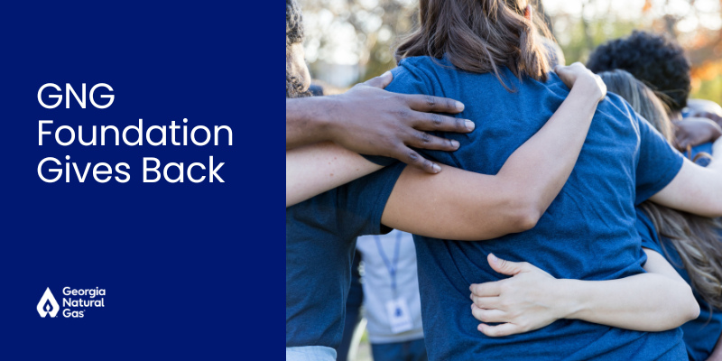 group of people hugging with white text that says GNG Foundation Gives Back