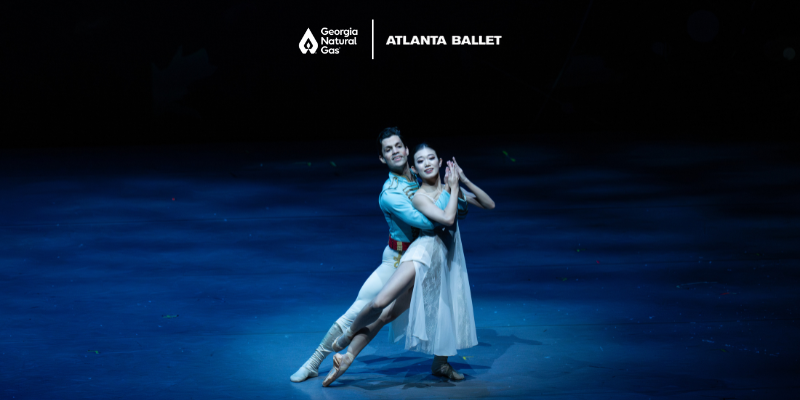 Performers in costume on a dark stage. GNG and Atlanta Ballet logos in white.