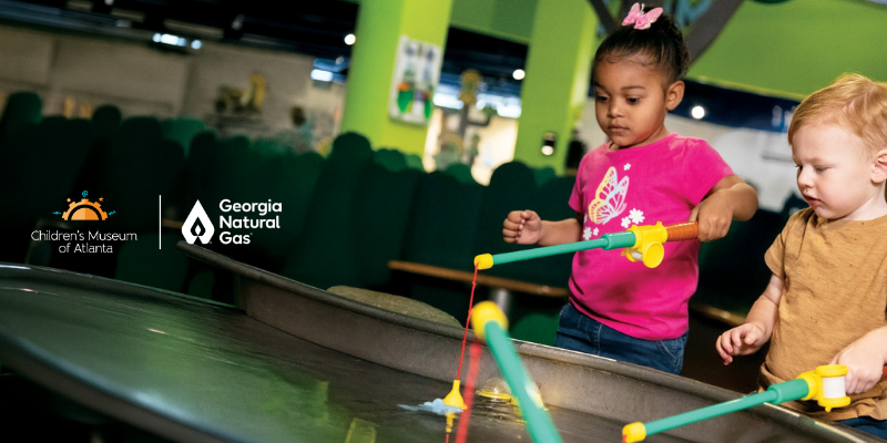 Two children playing with toys. GNG CMA logos