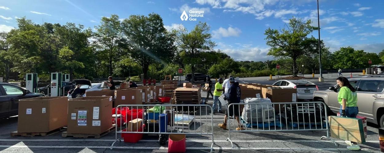 People collecting electronics to recycle in boxes