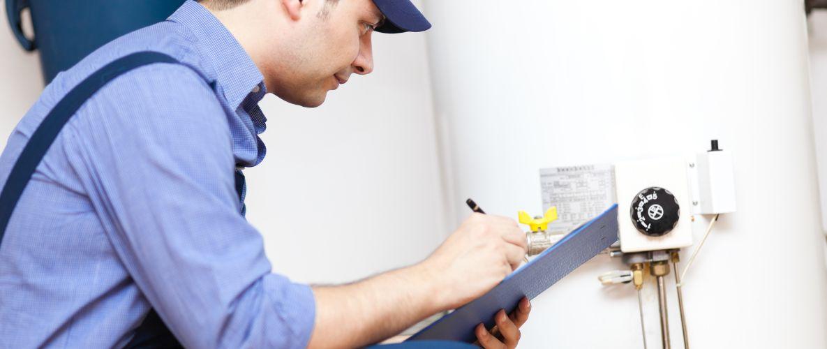 Man inspecting hot water heater