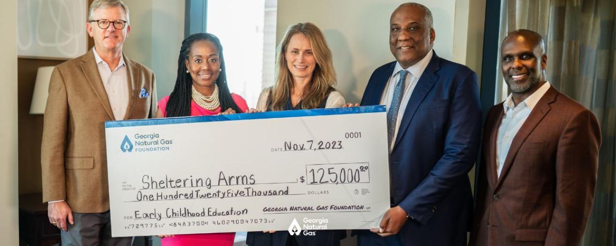 Group of people at a check presentation