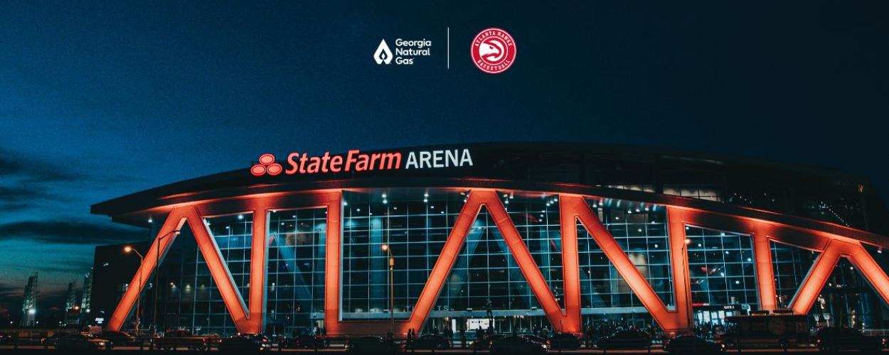 Photo of State Farm Arena at Night with GNG and Hawks logo lockup