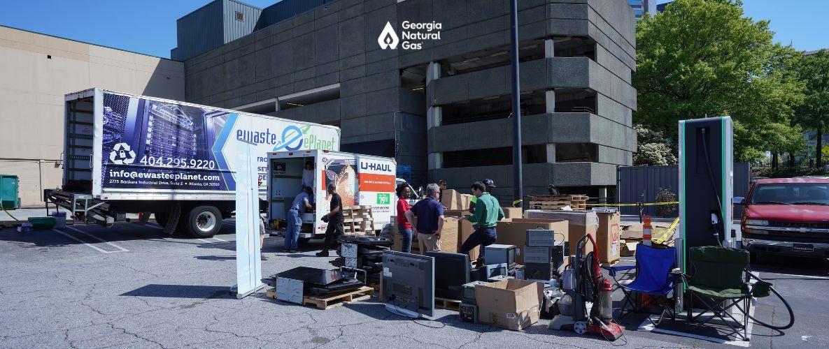 People collecting electronics to recycle in boxes