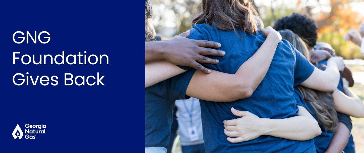 group of people hugging with white text that says GNG Foundation Gives Back