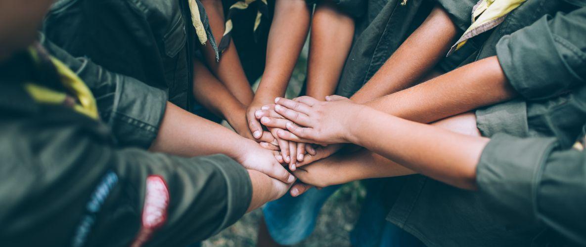 Boy Scouts with hands together in a circle