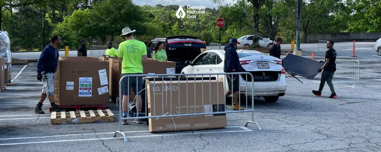 People collecting electronics to recycle in boxes